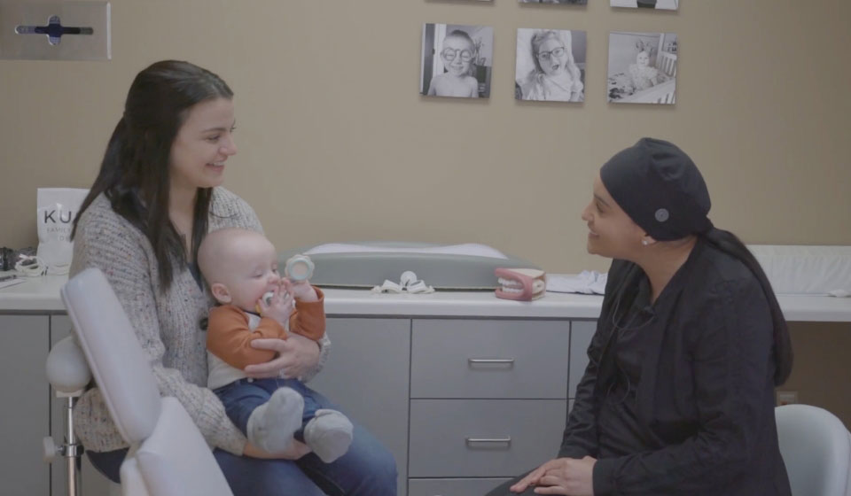 woman bringing her child to Sioux Falls dental office Kusek Family & Implant Dentistry