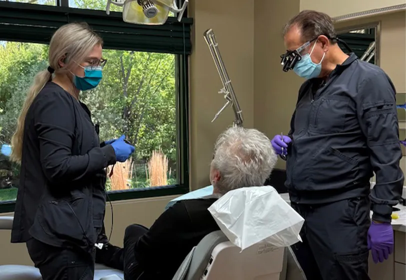 Dr. Kusek and dental assistant introducing themselves to a new patient and explaining procedure